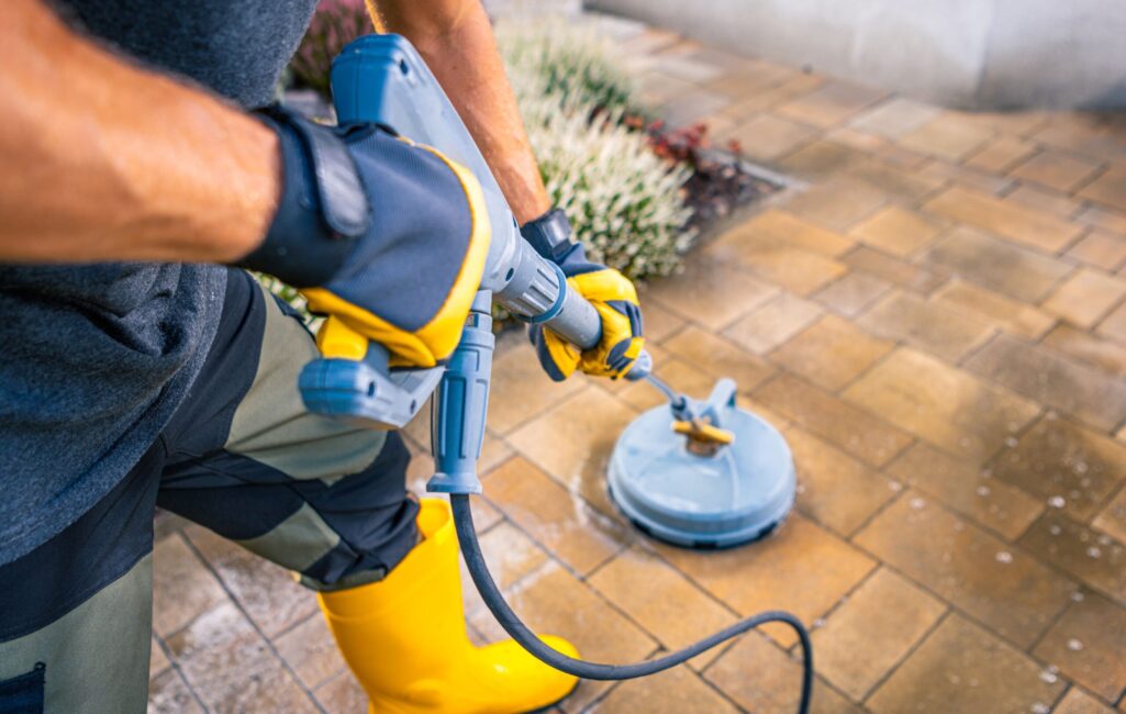 person-using-a-pressure-washer-on-a-patio-in-a-res-2025-03-16-20-31-20-utc